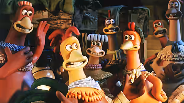 Several chickens gathered closely together looking upward with concern