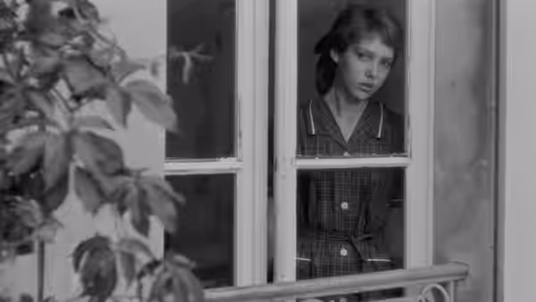 Marie (Anne Wiazemsky) looks out through a window