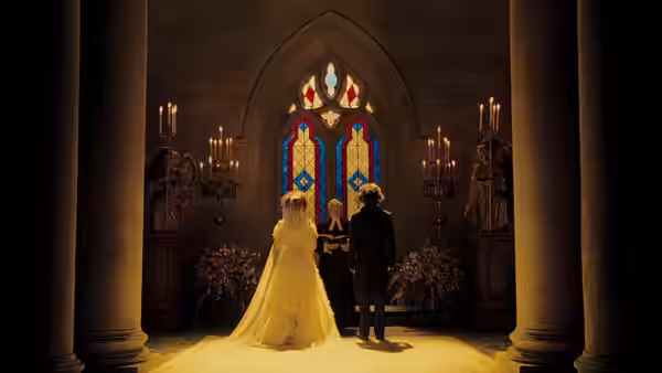 Johanna (Jayne Wisener) and Anthony (Jamie Campbell Bower) at their wedding in a church