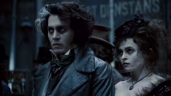Sweeney Todd (Johnny Depp) and Mrs. Lovett (Helena Bonham Carter) standing together at night
