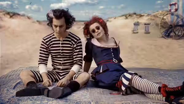 Sweeney Todd (Johnny Depp) and Mrs. Lovett (Helena Bonham Carter) sitting on the beach