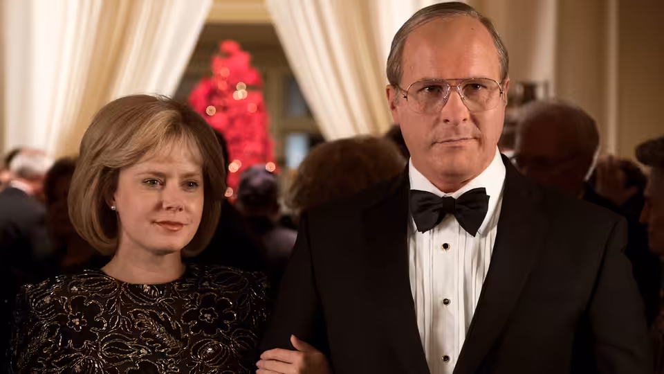 Dick Cheney (Christian Bale) stands with Lynne Cheney (Amy Adams) at a formal event