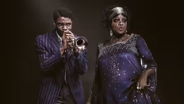 Levee (Chadwick Boseman) plays trumpet beside Ma Rainey (Viola Davis) in performance