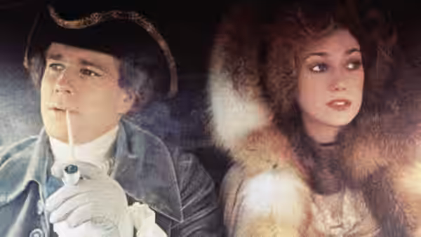 Barry Lyndon (Ryan O'Neal) smokes a pipe beside a woman in fur