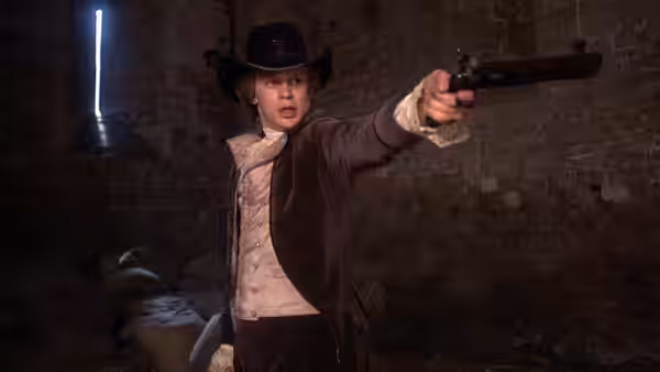 A figure in velvet coat and tricorn hat aims a pistol in ruins