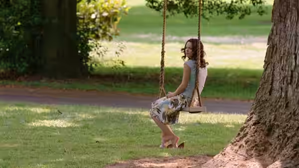 Claire Cleary (Rachel McAdams) sits on a swing beneath a tree