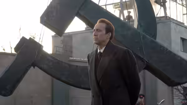 Yuri Orlov (Nicolas Cage) stands beside a cargo ship's loading crane