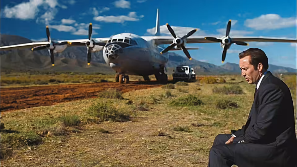 Yuri Orlov (Nicolas Cage) sits in a field beside a military transport plane