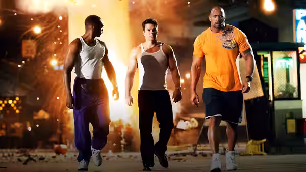 Daniel Lugo (Mark Wahlberg), Adrian Doorbal (Anthony Mackie), and Paul Doyle (Dwayne Johnson) walk through a city street