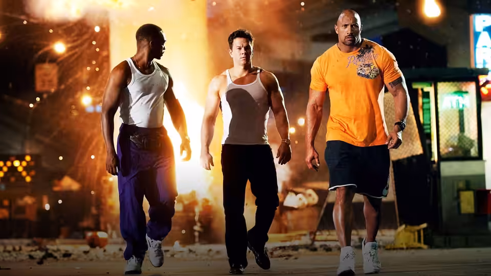 Daniel Lugo (Mark Wahlberg), Adrian Doorbal (Anthony Mackie), and Paul Doyle (Dwayne Johnson) walk through a city street