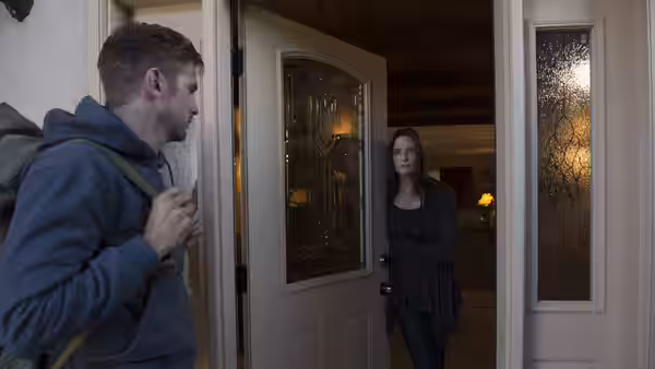 David (Dan Stevens) faces a woman at the open front door
