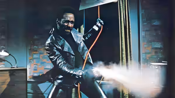 John Shaft (Richard Roundtree) directs a powerful spray from a hose indoors