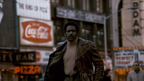 John Shaft (Richard Roundtree) walks through a city street in a leather jacket