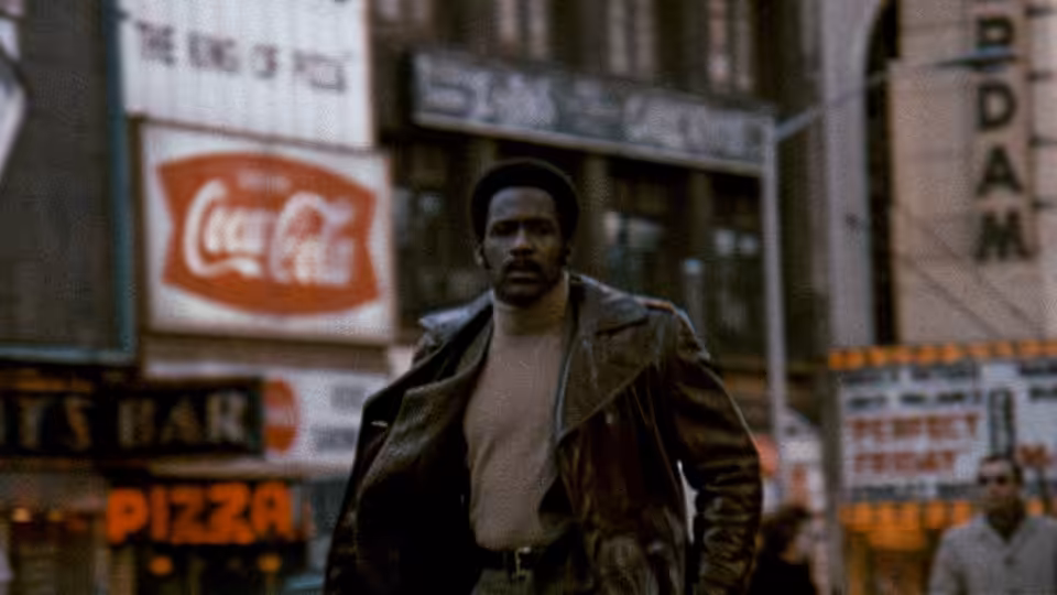 John Shaft (Richard Roundtree) walks through a city street in a leather jacket