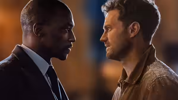 Two men stand face to face in a tense nighttime confrontation