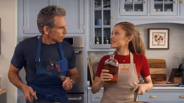 Greg Focker (Ben Stiller) and Olivia Jones (Ariana Grande) in a kitchen