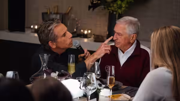 Greg Focker (Ben Stiller) points at Jack Byrnes (Robert De Niro) across a dinner table