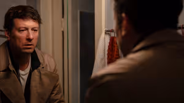 Two men facing each other in a doorway or hallway