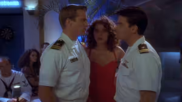Ramada Thompson (Valeria Golino) stands between two uniformed naval officers at a party