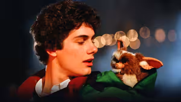 Billy Peltzer holds a small furry creature close to his face