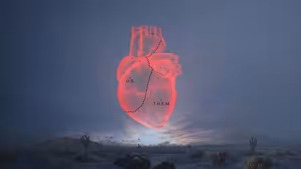 a glowing red heart floating above a desert landscape labeled U.S. and THEM