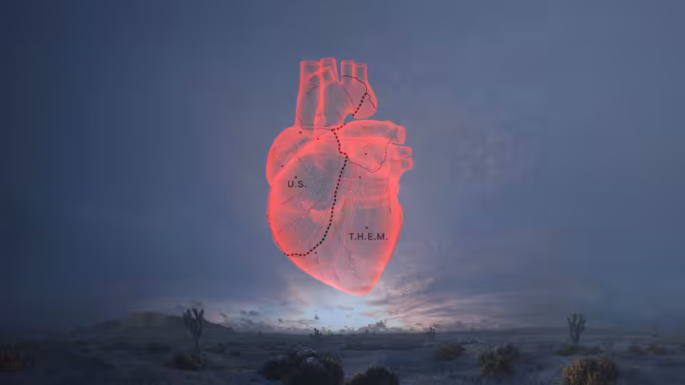 a glowing red heart floating above a desert landscape labeled U.S. and THEM