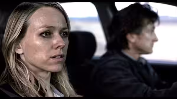 Cristina Peck (Naomi Watts) in the passenger seat of a car