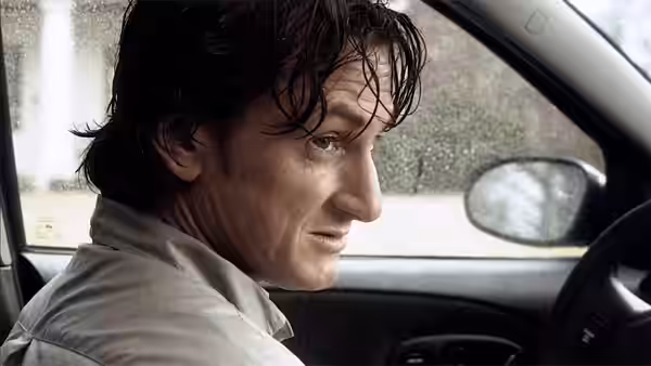 Paul Rivers (Sean Penn) behind the wheel of a car