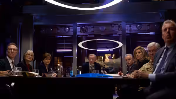 Officials seated around a long table in a modern conference room