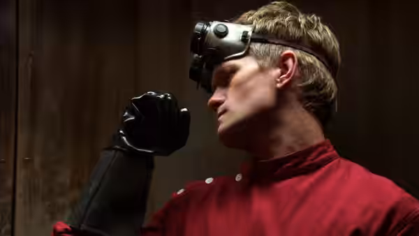 Dr. Horrible (Neil Patrick Harris) in a red turtleneck with goggles on his head