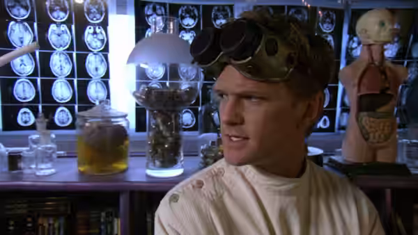 Dr. Horrible (Neil Patrick Harris) in a laboratory wearing goggles and a lab coat