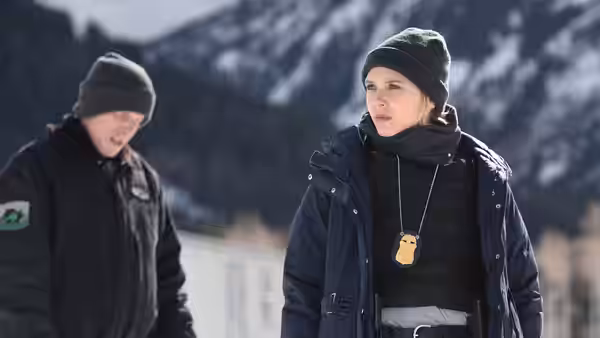 Jane Banner (Elizabeth Olsen) stands in the snow near mountains