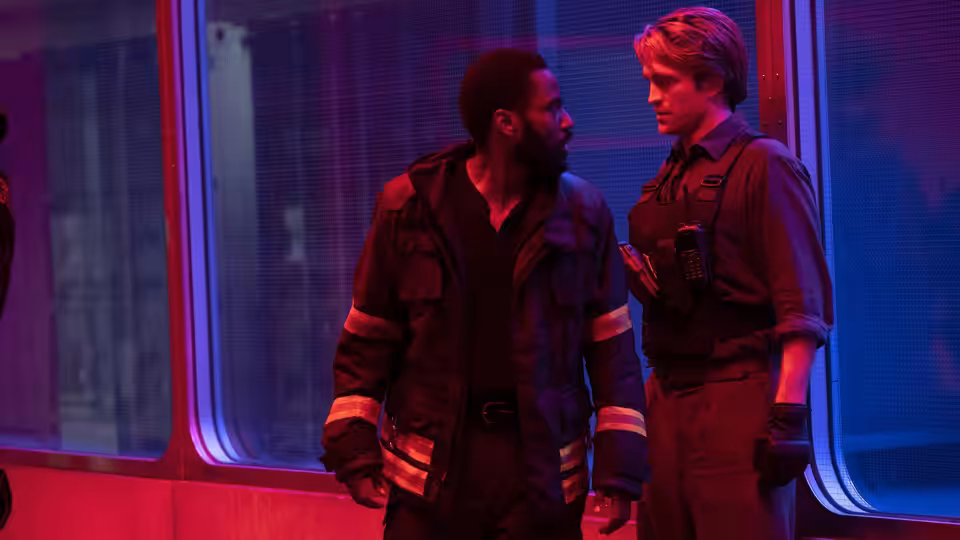 Protagonist (John David Washington) and Neil (Robert Pattinson) facing each other by large windows