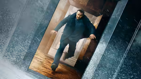 Joel Edgerton jumps through a shattered doorway onto wooden stairs