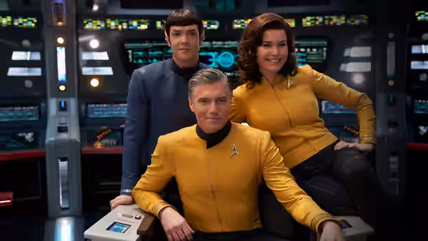 Captain Pike (Anson Mount) seated with Spock (Ethan Peck) and Una (Rebecca Romijn) on the bridge