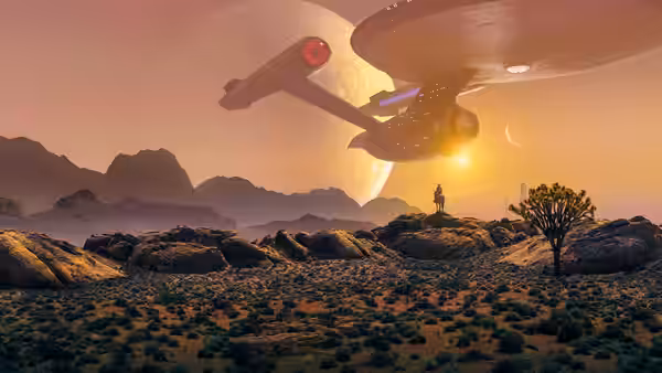 The Enterprise flying over a rocky desert planet at sunset near a lone figure