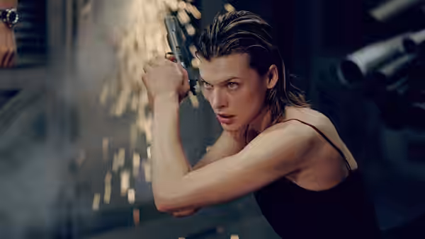 Alice (Milla Jovovich) aiming a pistol amid flying sparks