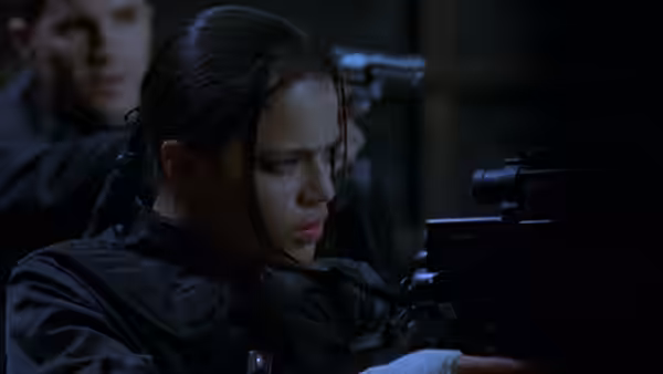 Rain (Michelle Rodriguez) aiming a large weapon intently