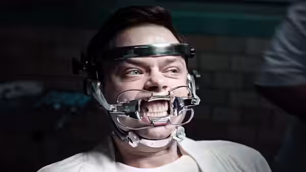 Lockhart (Dane DeHaan) wears a dental brace in a treatment room