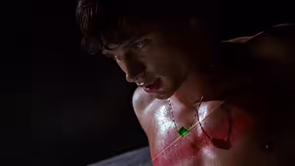 Clark Kent (Tom Welling) shirtless with red marks and green necklace
