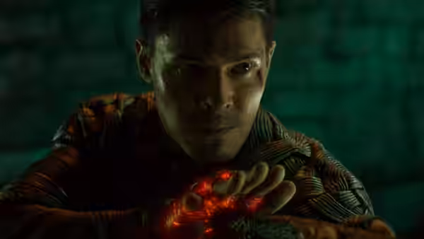 Liu Kang (Ludi Lin) holding glowing red energy in his hands at night