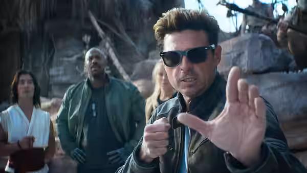 Johnny Cage (Karl Urban) gesturing with an open hand in a rocky outdoor setting