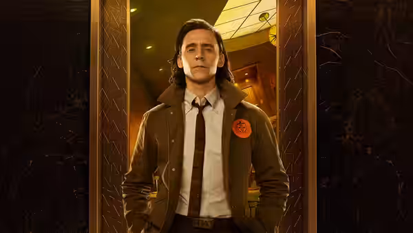 Loki (Tom Hiddleston) stands in an ornate doorway with hands in pockets