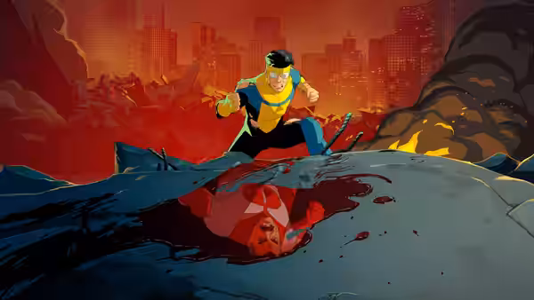 Hero in yellow and blue suit stands over defeated red masked figure in devastated landscape