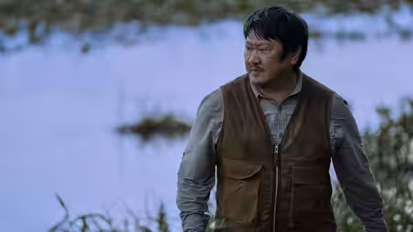 Benedict Wong as Detective Shi standing by the water