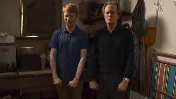 Tim (Domhnall Gleeson) stands beside his father (Bill Nighy) in a workshop