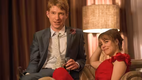 Tim (Domhnall Gleeson) sits with Mary (Rachel McAdams) in a formal living room