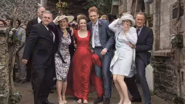 Tim (Domhnall Gleeson) and Mary (Rachel McAdams) pose with family at their wedding