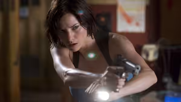 Alice (Milla Jovovich) aiming a pistol with attached flashlight