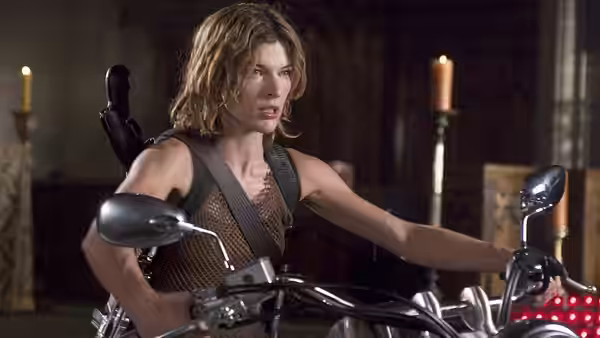 Jill Valentine (Sienna Guillory) gripping handlebars of a motorcycle